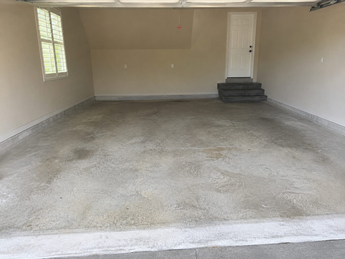 Bare dusty concrete garage floor before epoxy